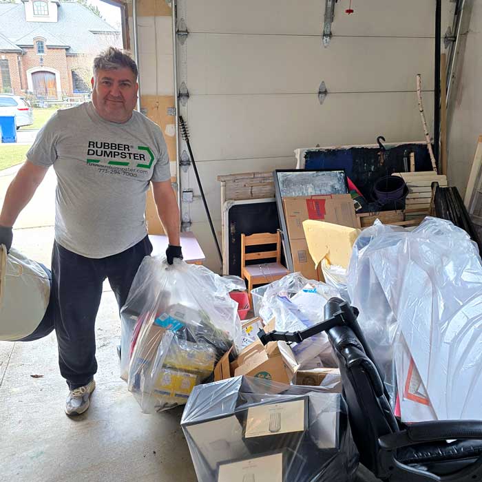 A Rubber Dumpster worker cleaning out the garage Glenview, IL