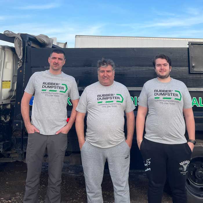 A Rubber Dumpster crew standing in the front of dumpster truck Glenview, IL